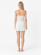 White eyelet spaghetti-strap tankini and ruffle mini swim skirt back view